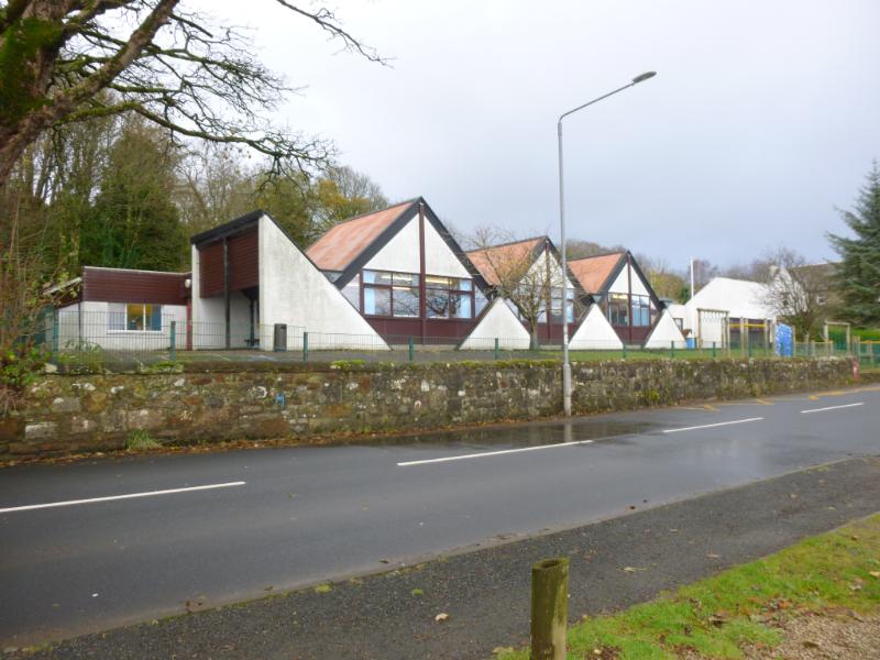 Whiting Bay Primary School, principal elevation looking east, taken from southeast during daytime with cloudy sky with road in front.  