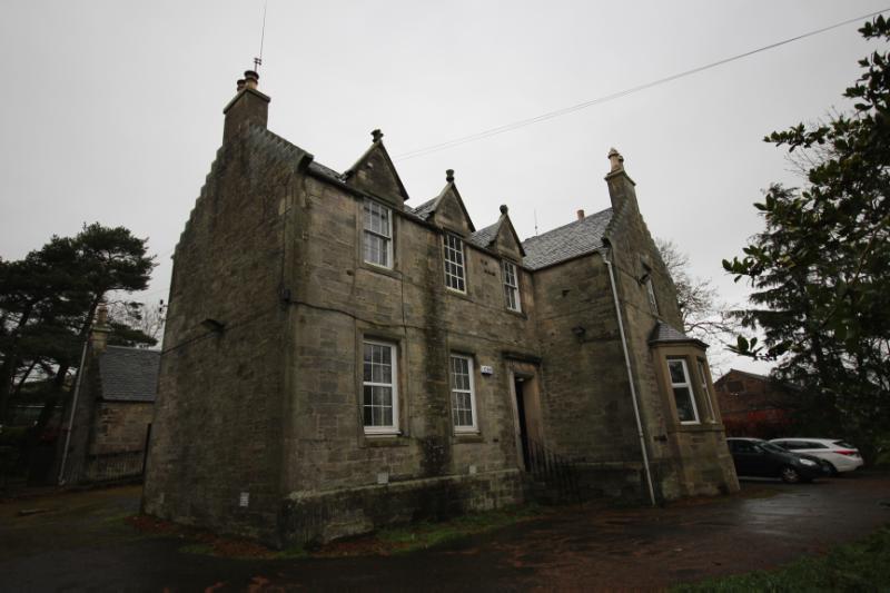 Boghall Farmhouse principal elevation, looking north, during daytime, on a rainy day with grey sky.