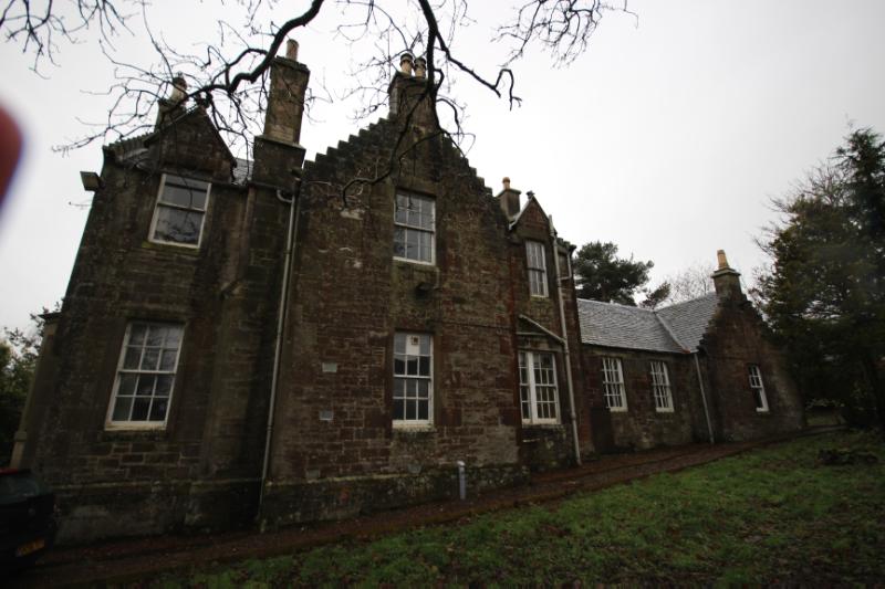 Boghall Farmhouse, northeast elevation, looking southwest, during daytime, on a rainy day with grey sky.