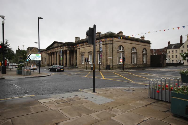 Perth Sheriff Court and Justice of the Peace Court, north and east elevation, looking southwest, during daytime on an overcast day and with traffic lights in the foreground. 