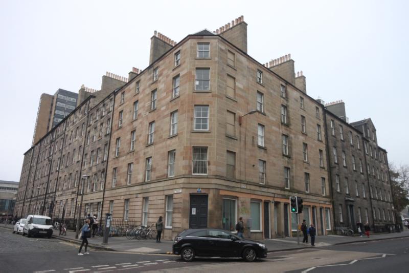 36-37 Buccleuch Place and 16-26 Buccleuch Street, Edinburgh, view from southeast, with black car in foreground and overcast sky.