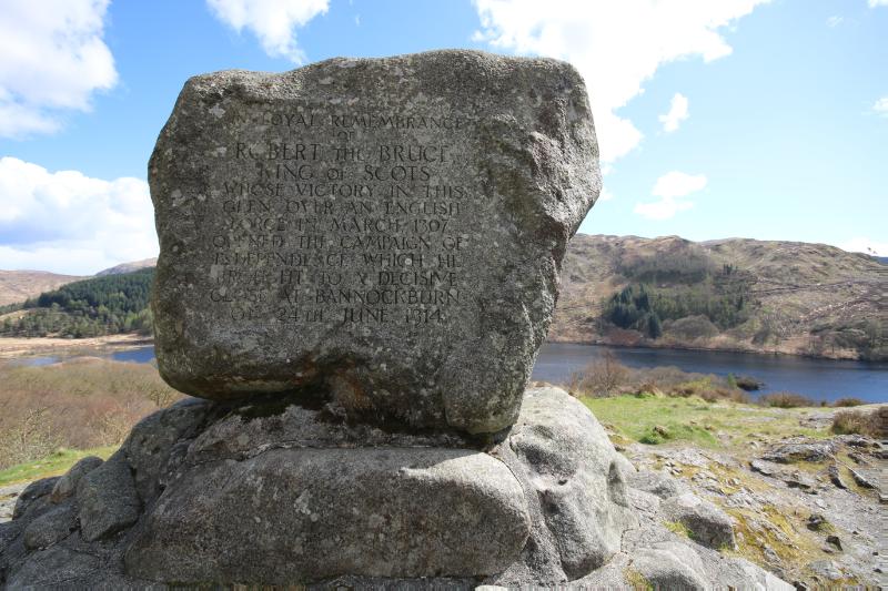 Detail of inscription on Bruce’s Stone, Loch Trool, looking south with Loch Trool and hill to rear. 