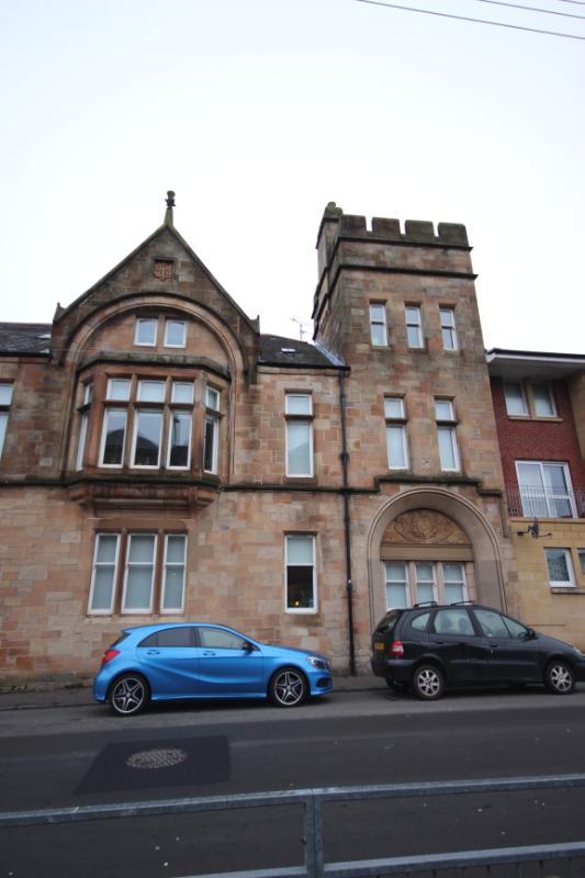 31 and 33 Coplaw Street, detail of entrance bay on south elevation with cars parked in front of the building, looking north, during daytime on a dull day.