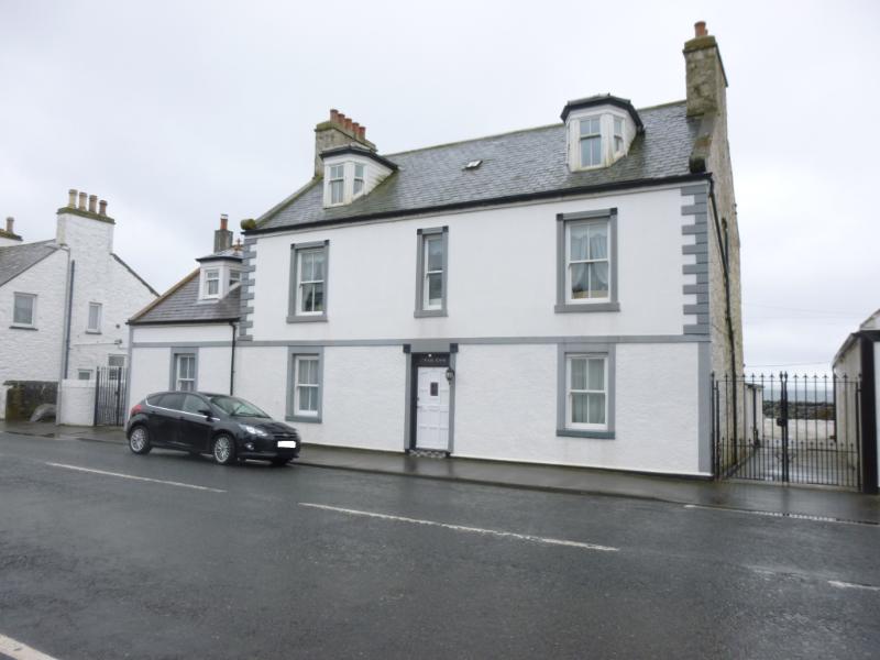 4 Main Street, Port William, east facing street elevation on a rainy day with dull sky.  
