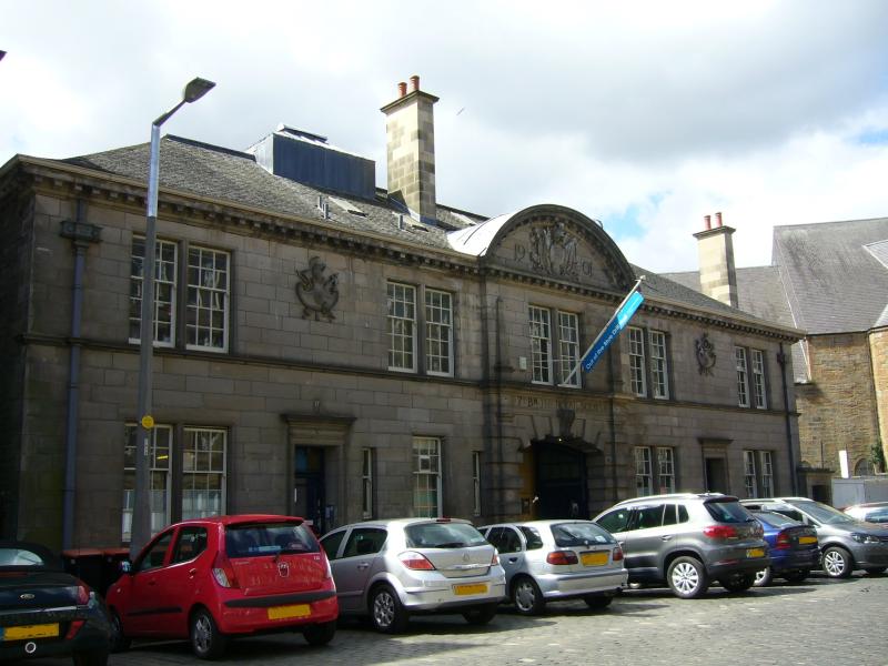 The Out of the Blue Drill Hall, Dalmeny Street, principal elevation with parked cars in front of building, on a sunny day with blue sky and white clouds.