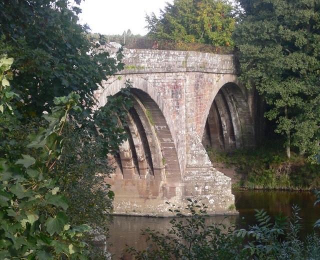 Upper North Water Bridge, looking southwest, with trees to at the edge of the river, during daytime on a sunny day.