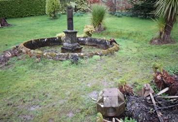 Sundial and stone basin to northwest of Kelburn Castle, looking north, on a wet and cloudy day