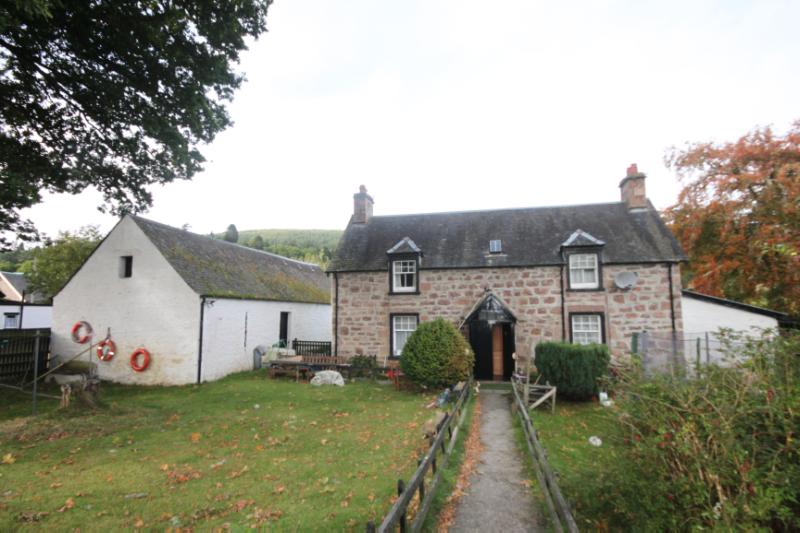Lock Keeper’s Cottage and Barn, Dochgarroch Locks, Caledonian Canal, looking northwest, during daytime on a cloudy day. 