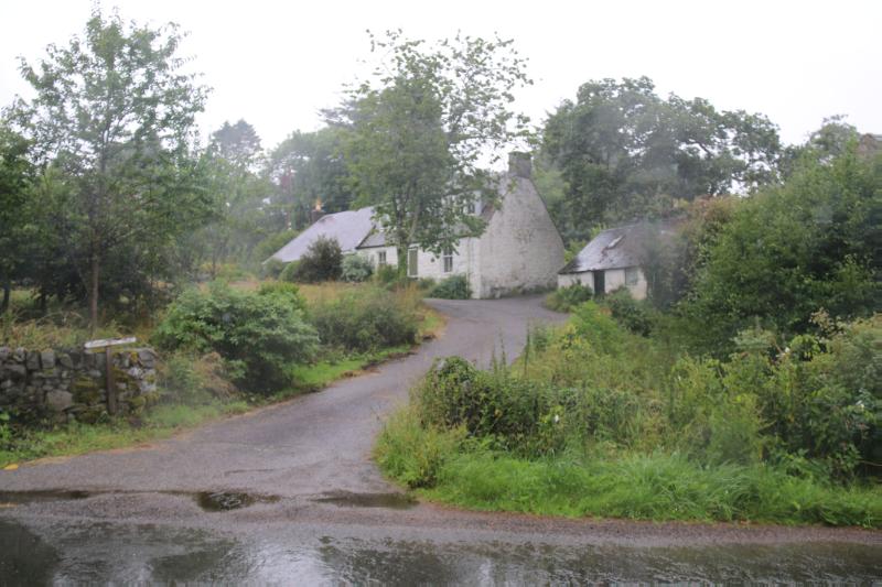 Barnhourie Mill entrance to garden, looking north on a rainy day with cloudy sky. 