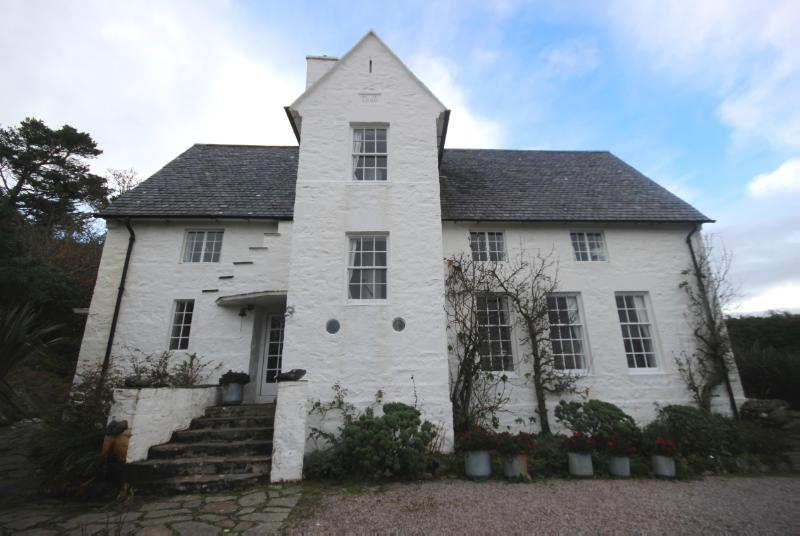 Dun A Bhuilg House, principal elevation, looking west during daytime with blue sky and cloud. 