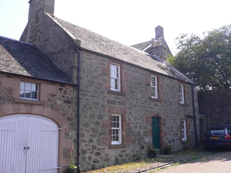 Mornington Cottage, street elevation, looking southeast, during daytime on a sunny day.