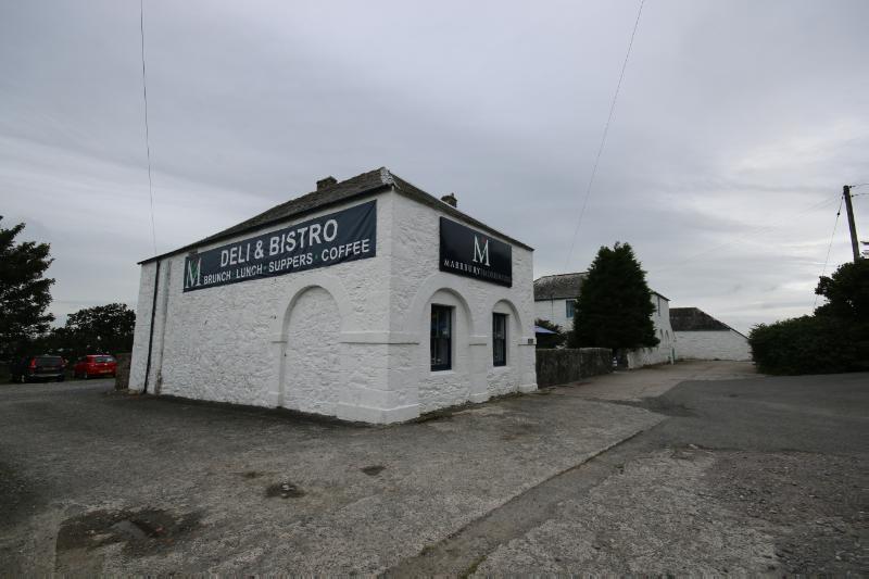 Former steading, southeast pavilion, looking west, during daytime, on a cloudy day.