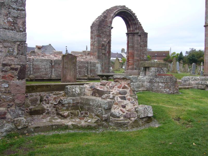 Coldingham Priory, south transept arch, looking southeast during daytime on a cloudy day