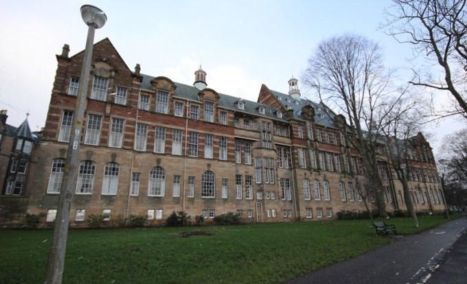 North elevation, University of Edinburgh, Former Boroughmuir School, 22-24 Warrender Park Crescent, Including Boundary Wall, Railings and Gatepiers, Edinburgh, grass, trees and lamppost in foreground.