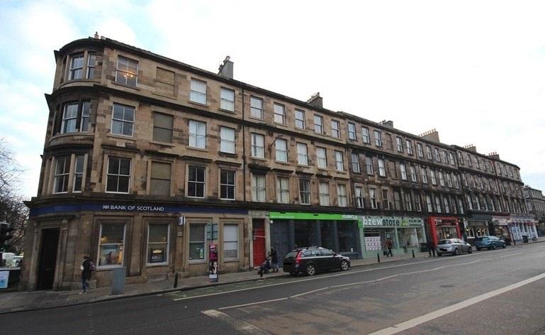 West elevation, 51-77 South Clerk Street, Edinburgh, road and cars in foreground. Taken on cloudy day.