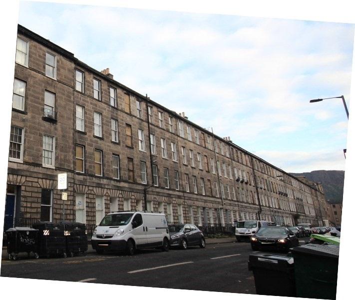 Southeast elevation, 7-57 Montague Street and 75-79 St Leonard’s Street, Edinburgh, cars in foreground, taken on cloudy day.