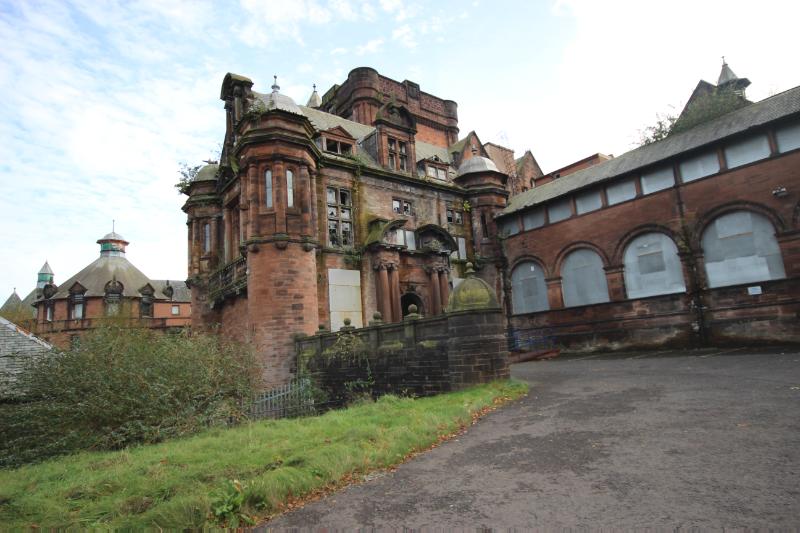 Former Royal Alexandra Infirmary, Neilston Road, Paisley, entrance section, looking southeast during daytime on sunny day with blue sky. 