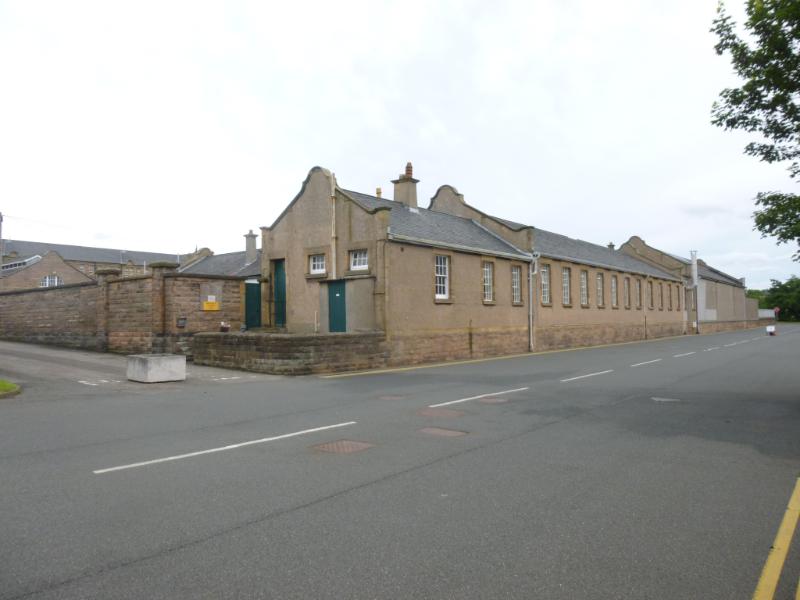 Buildings 40, 42, 43 and 44, Redford cavalry barracks, Colinton Road, Edinburgh, southwest elevation, during daytime, on dull day with cloudy sky and road in front.  