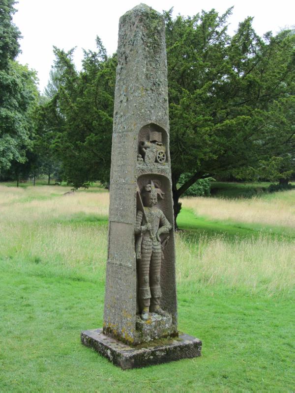 King James Obelisk showing carving of King James I of Scotland, with trees to rear, Dryburgh Abbey.
