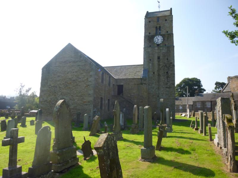 St Serf's Church, view across graveyard to north face of tower, looking south, during daytime, on a clear day with blue sky.
