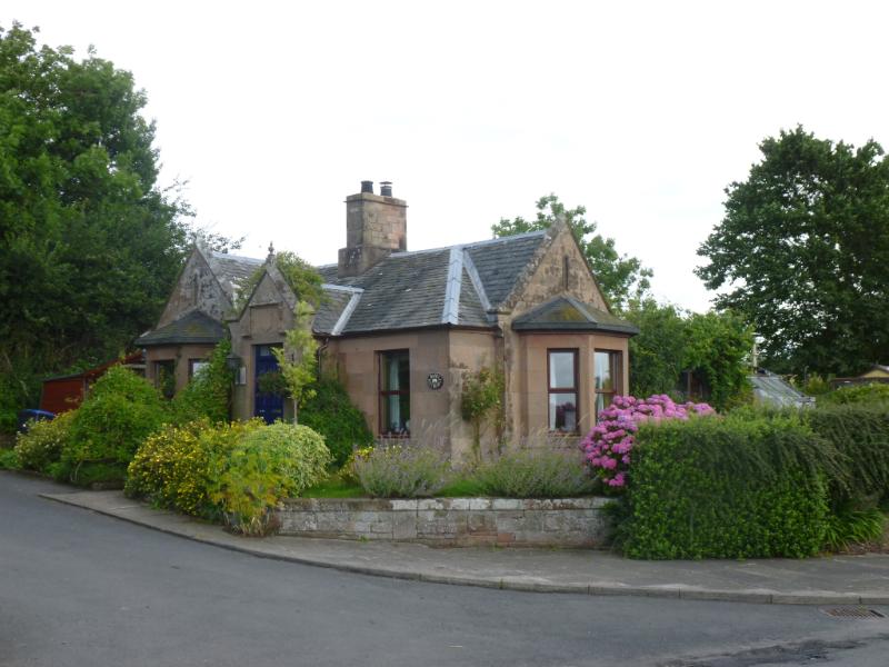 Maines South Lodge, principal elevations, looking northeast, during daytime, on a cloudy day.