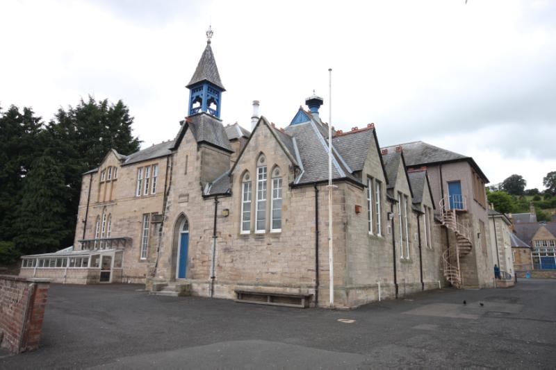 Jedburgh Grammar School, from northeast, showing front and north elevations, during daytime on clear day with white clouds in sky.