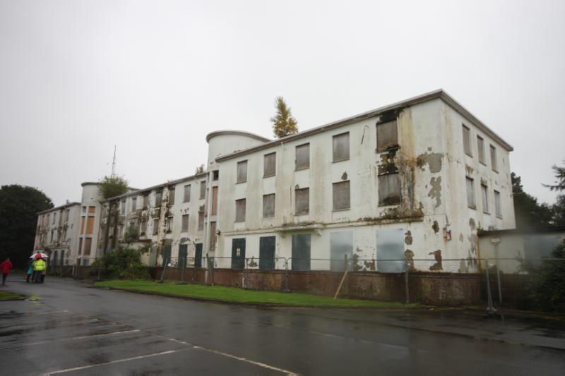 Eastern Block of Maternity Residences, north elevation, Ayrshire Central Hospital, looking southeast, during daytime, on wet and cloudy day with grey sky.