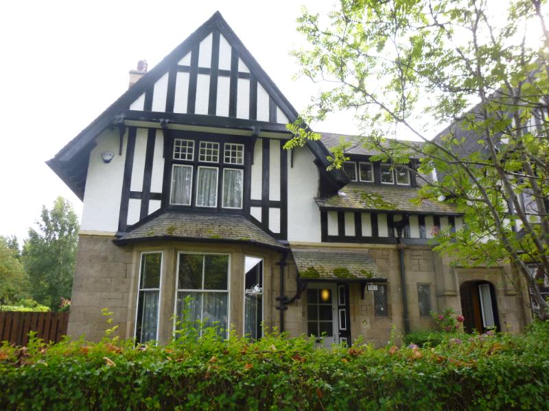 Sherwood, 583 Anniesland Road, Glasgow, principal elevation, looking south during daytime with a hedge and tree in front of the property