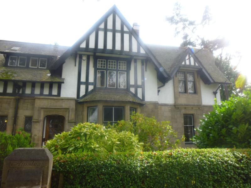 Ainslea, 585 Anniesland Road, Glasgow, principal elevation, looking south, during daytime with hedging in front of property.