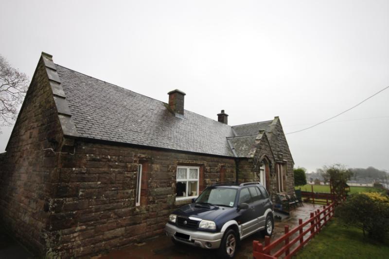 Copper’s Cottage, west elevation, looking southeast, during daytime, on overcast day with cloudy sky.