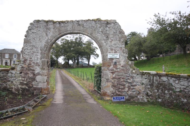Dirleton Castle Gate looking northwest, during daytime, on clear day with cloudy sky.
