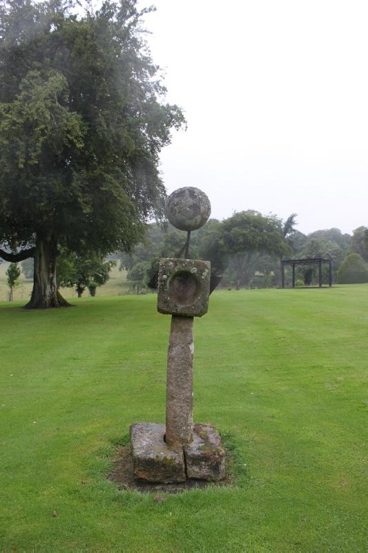 Sundial at Pittodrie House, looking east, during daytime, with trees behind the sundial