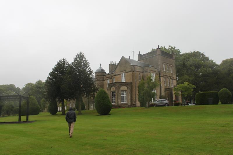 Pittodrie House, east and south elevation with monkey puzzles trees and bushes in front of the house