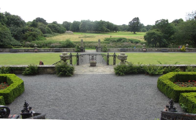 View south from Pollok House garden terraces, during daytime, trees in distance. 