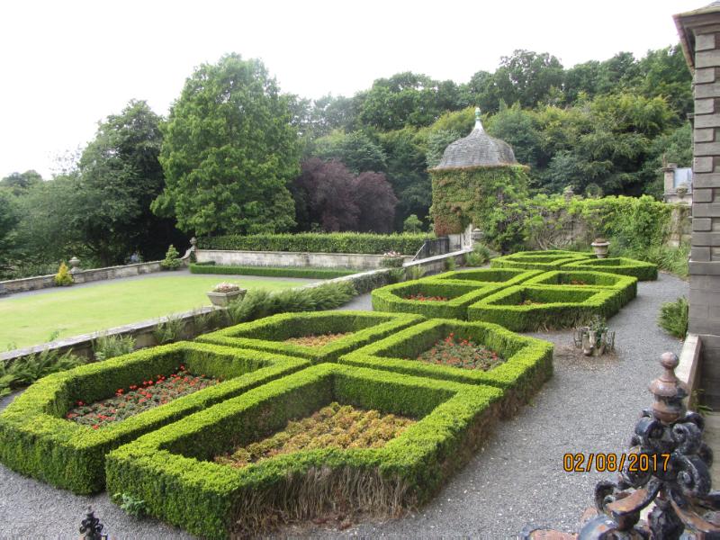 Pollok House formal garden scheme, hedge parterre to foreground, trees to background, ivy-covered pavilion building
