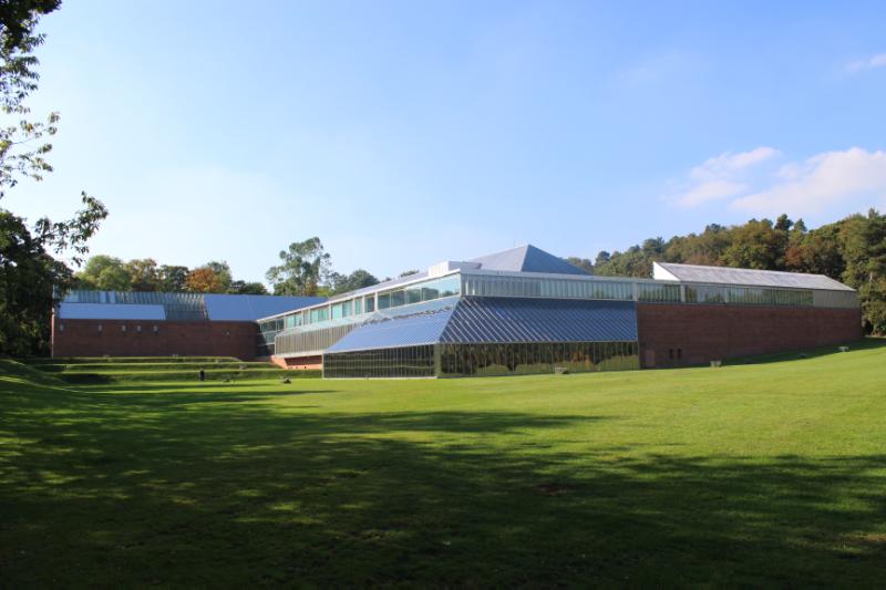 Burrell Museum on a sunny day, grass to foreground, blue sky