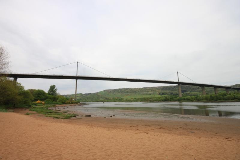 Erskine Bridge, general view looking north from Boden Boo beach during daytime with cloudy sky.
