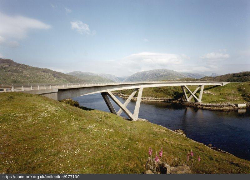 Drochaid a’ Chaolais Chumhaing, An Caolas Cumhang / Kylesku Bridge, Kylesku, west elevation, looking southeast, during daytime, on clear day with blue sky.