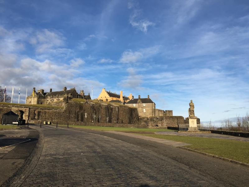 Exterior of Stirling Castle from esplanade looking north during daytime, with blue sky. 