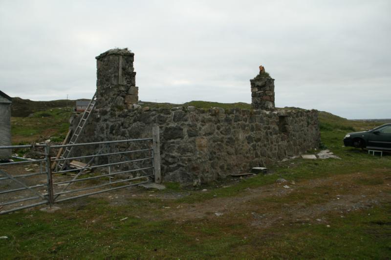 Cottage to the north of 472b South Lochboisdale, rear elevation looking northwest, during daytime, on clear day with overcast sky. 