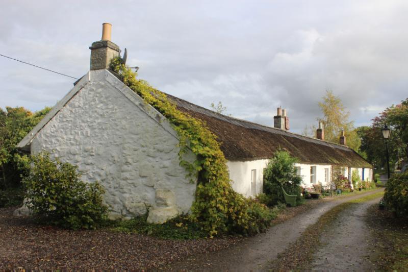 Old Burnside Cottages, principal (south) elevation and west elevation, looking east, during daytime, on cloudy day. 