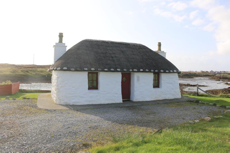 Ronald’s Cottage, principal elevation, looking west during daytime, on clear day with blue sky. 