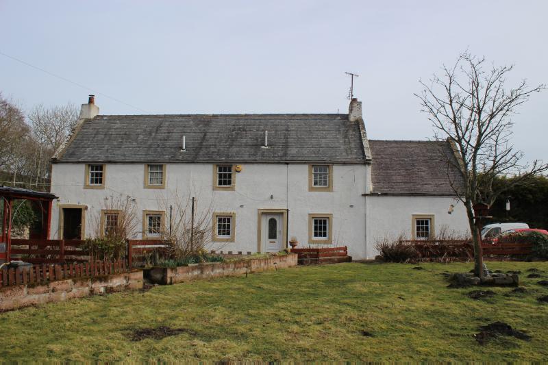Honbu Cottage, principal elevation, looking northeast during daytime, on clear day with blue sky. 