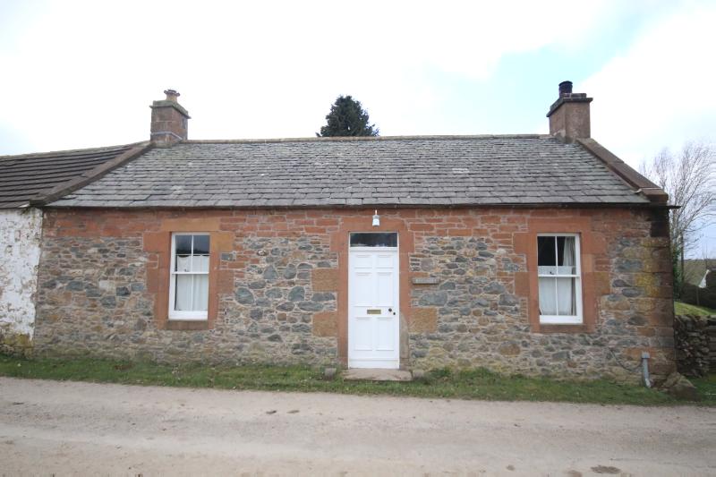 Ryecroft cottage (with adjoining steading row to left) looking west, during daytime.