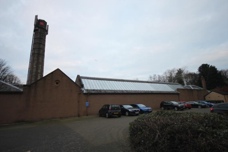 Former McLagan and Cumming Printworks, east elevation with view of chimney, looking west, during daytime on overcast day.