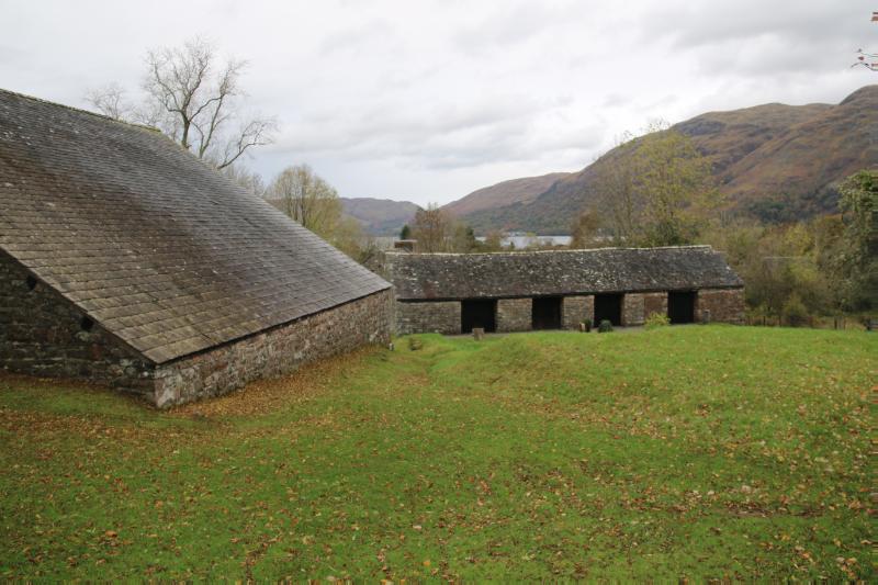 View of ore and charcoal sheds at Bonawe, looking northwest with Loch Awe in the distance taken on an overcast day.