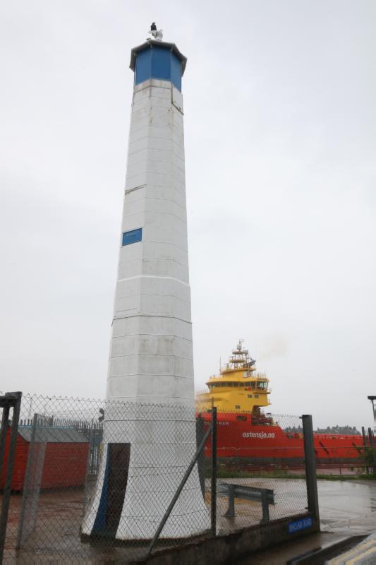 Southwest (Inner) Tower looking west during rain with white sky. 