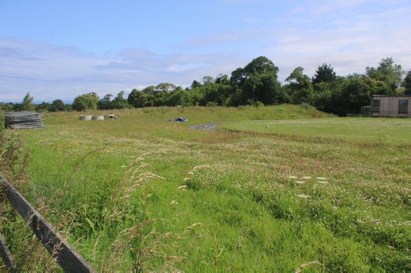 Seton Mains, fort, looking north-east over the interior on a sunny day with blue sky.