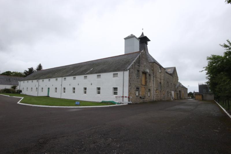 Malting and distilling buildings at Dallas Dhu Distillery, looking northwest towards the south elevation of the malt barn, during daytime.