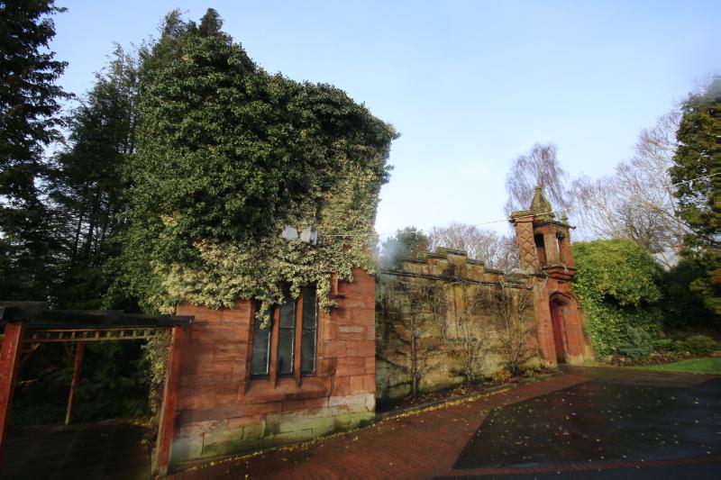 Viewpark Gardens, entrance, heated wall and corner tower looking northwest, during daytime with blue sky. 